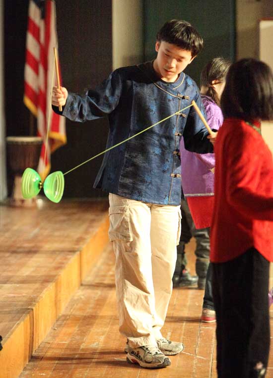 David Young performs tricks with a Chinese yo-yo during a performance with his siblings.